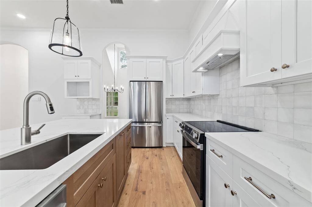 Stunning kitchen with sleek white cabinetry and a beautifully designed island centerpiece.