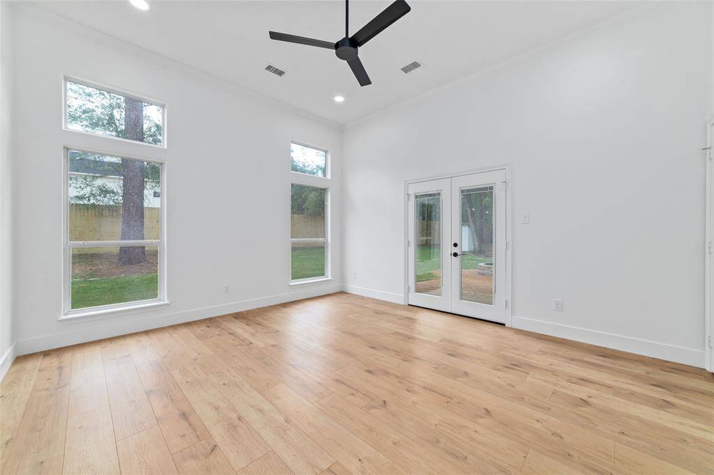 Elegant French doors in the primary bedroom open directly to the inviting backyard patio.