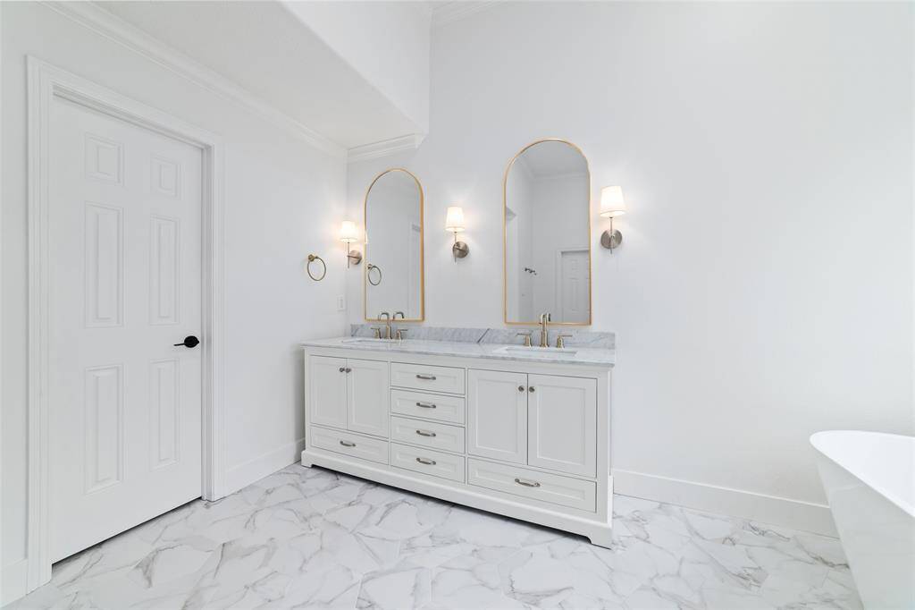 Luxurious primary bath featuring elegant double sinks.