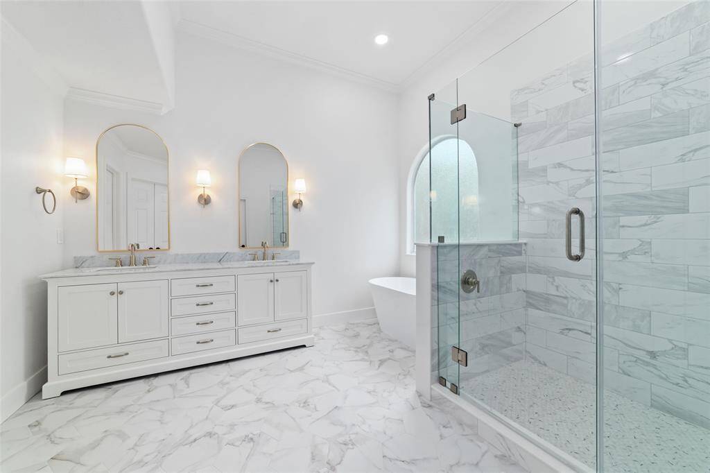 Spacious primary bath with elegant finishes and abundant natural light.