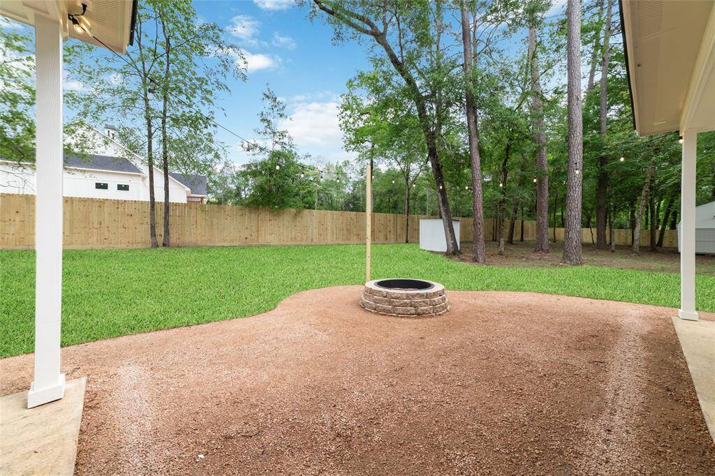 This expansive lot features a spacious patio and abundant green space for relaxation and outdoor activities.