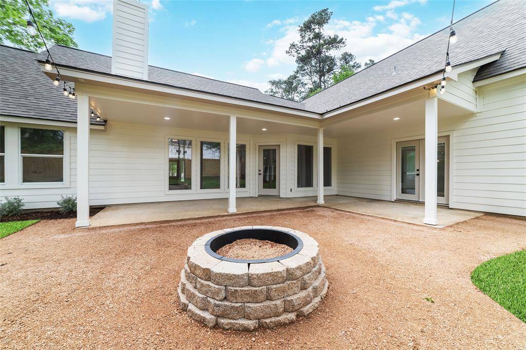 Inviting patio view showcasing the home's elegant rear facade, perfect for outdoor gatherings.