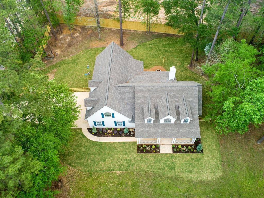 Charming home set in a lush, wooded area with a spacious backyard. Features a NEW roof, inviting front porch, and landscaped garden beds. Ideal for privacy and outdoor enjoyment.