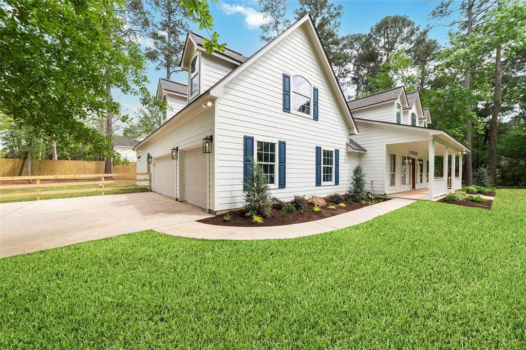 Spacious three-car garage with a wide driveway for ample parking.