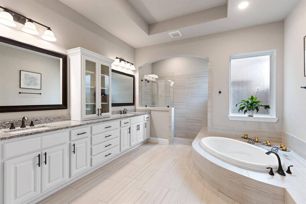 Primary bath with double sinks and plenty of storage.