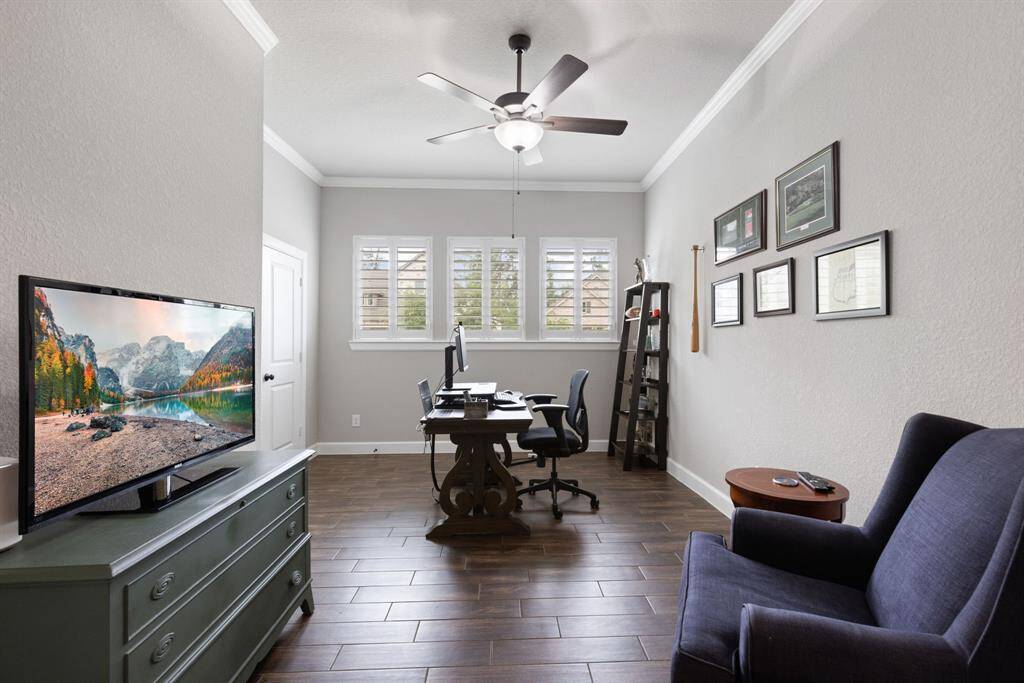 Fourth bedroom being used as a study, has a closet and glass french doors.