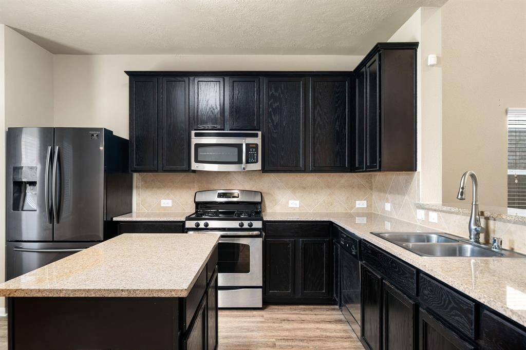 Any chef's dream, this stunning kitchen is perfect for everyday life as well as entertaining family and friends! Extra large kitchen island is perfect for conversation or that much needed space to lay out your party spread for everyone to enjoy! Large windows provide lovely views of your backyard and plenty of natural lighting throughout the day.