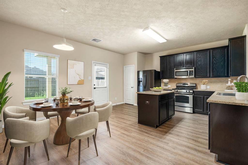 Bright and airy breakfast area just off the open kitchen perfect for casual dining or a morning coffee with a view. *Virtually Staged