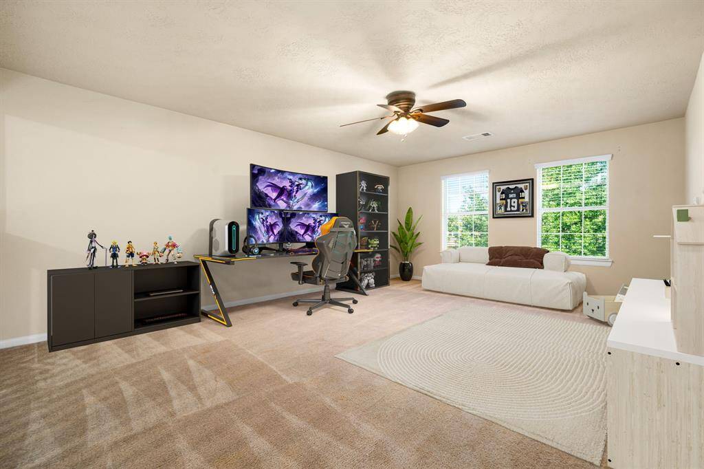 Perfect for entertaining is this amazing game room!  Right upstairs this space would be a fabulous teen hangout, media room, or adult game room with enough space for a pool table and big screen TVs. Featuring plush carpet, high ceilings, dark stained ceiling fan, custom paint and large windows with privacy blinds. *Virtually Staged