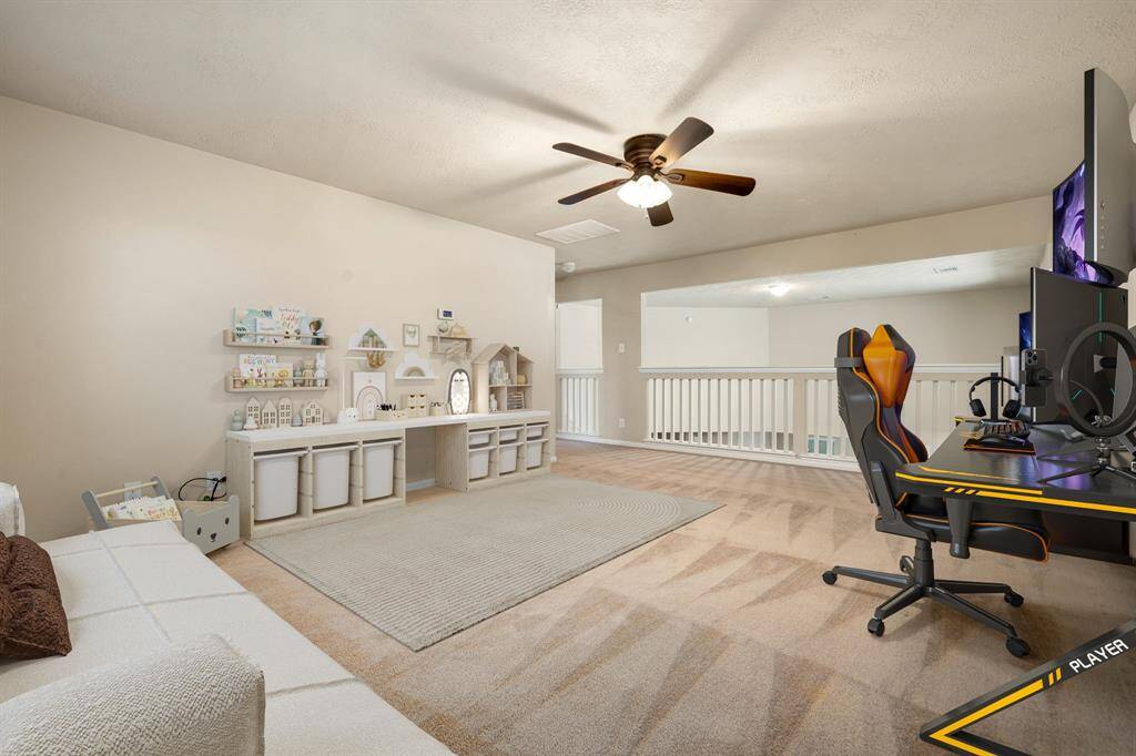 Come upstairs and enjoy a day of leisure in this fabulous game room/media room! This is the perfect hangout spot or adult game room, this space features plush carpet, high vaulted ceiling, recessed lighting, and custom paint. *Virtually Staged