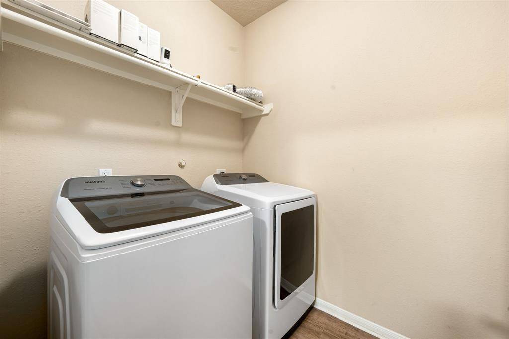 Spacious laundry area featuring convenient built-in shelving for all your essentials.