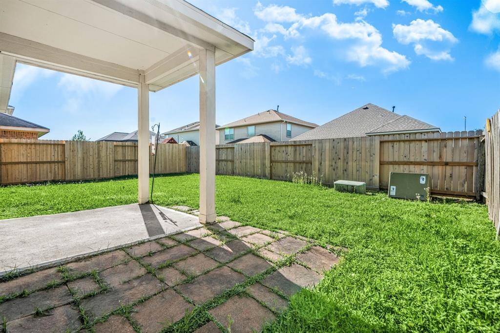 Relax in the shade of the covered patio, perfect for outdoor gatherings and enjoying the backyard.