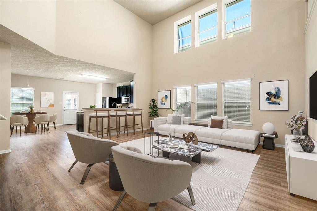 This light and bright spacious living room is the perfect layout for entertaining or just relaxing. Whether it's simply a night in or entertaining family and friends, this home has ample open space for everyone to enjoy! Featuring wood style flooring, large windows, soaring high ceilings, recessed lighting with wonderful access to your gorgeous kitchen. *Virtually Staged
