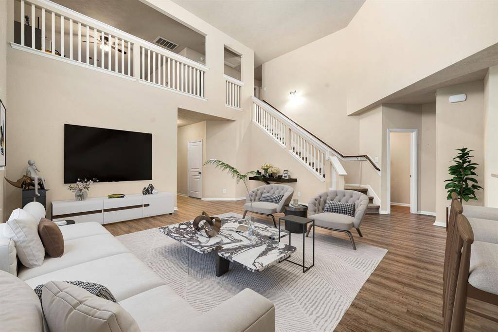 This living room is more like a GREAT room featuring custom paint, soaring high ceiling, recessed lighting, dark and an amazing wall of windows providing a lovely view of your backyard to keep an eye out on the kids or pets playing. *Virtually Staged