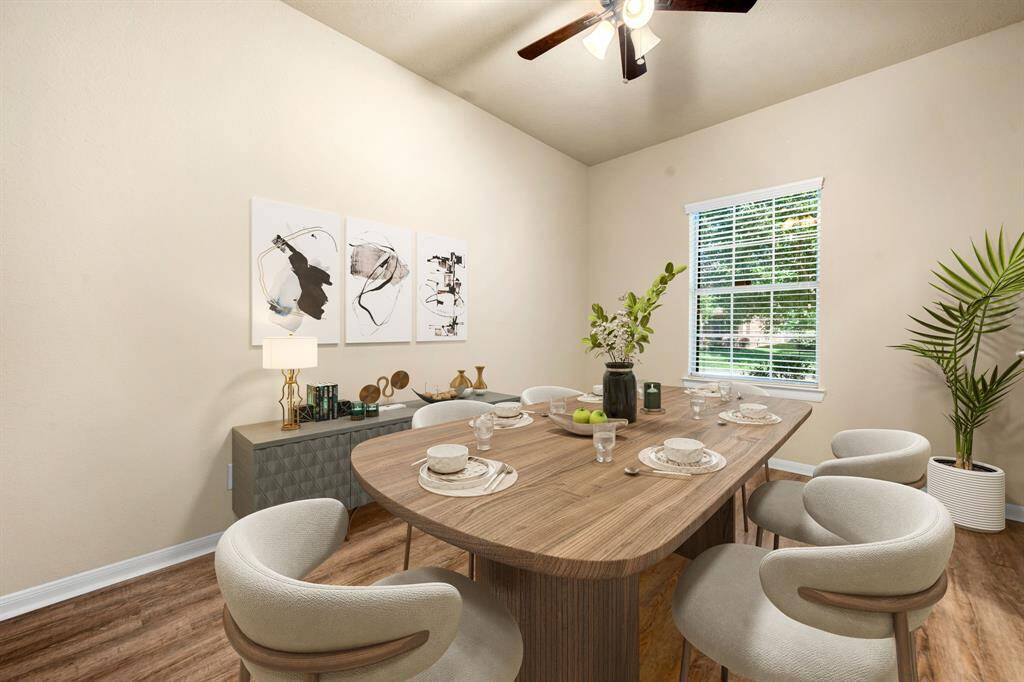 You and your guests will certainly dine in style in this amazing formal dining room! Featuring a gorgeous modern chandelier, large window with blinds, neutral paint, high ceilings, and wood style flooring. Perfect space to entertain family and friends. *Virtually Staged