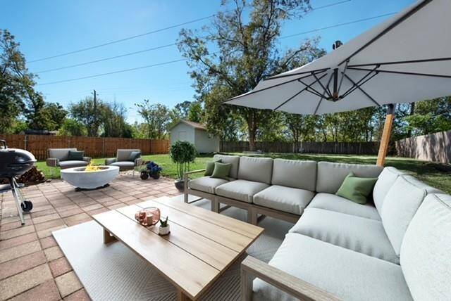 Expansive family room flooded with natural light, featuring walls of windows and seamless access to the private patio, perfect for indoor-outdoor living and entertaining. ( photo virtually staged)