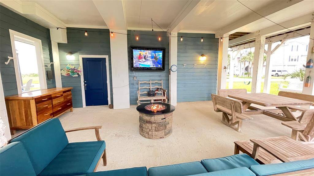 Family and Friends will love hanging out in this Downstairs Living Area with sectional sofa, weather-proof outdoor TV, firepit, picnic table porch swing....