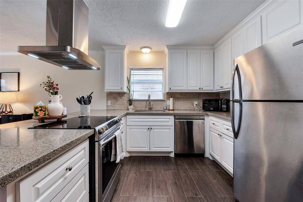 Sleek slide-in stove with electric cooktop. Plenty of cabinet space.
