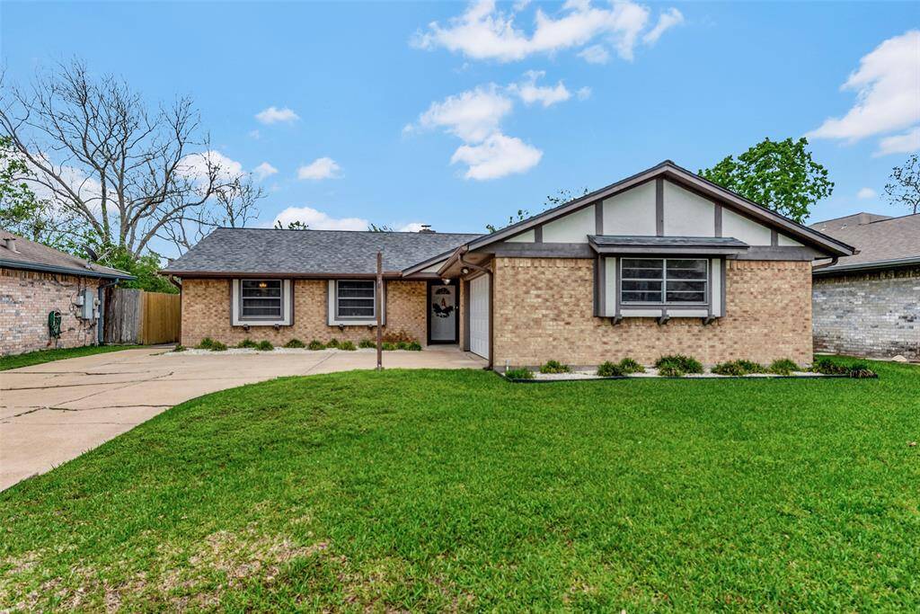 Charming landscaping in front of the two main windows and garage.