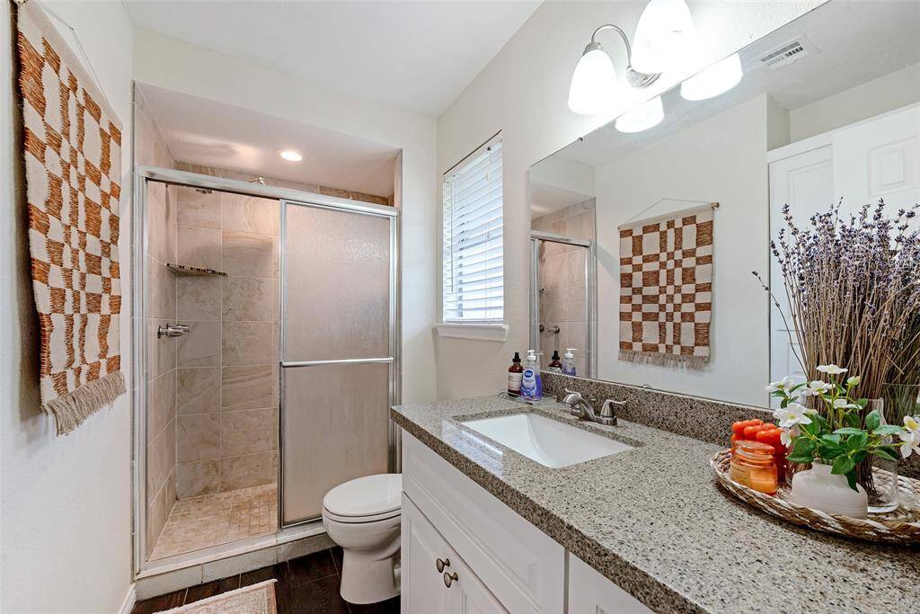 Primary bathroom with walk-in shower, spacious vainty with undermount sink.