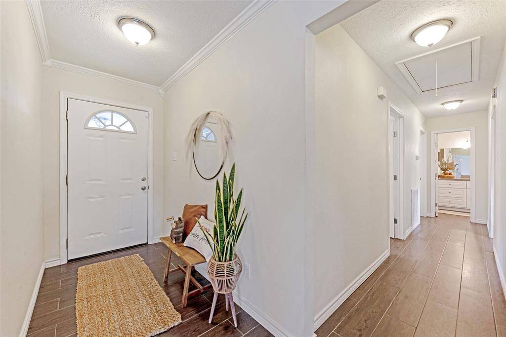 Wood look tile flooring and crown molding.