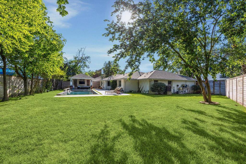 Tons of green space beyond the pool area.
