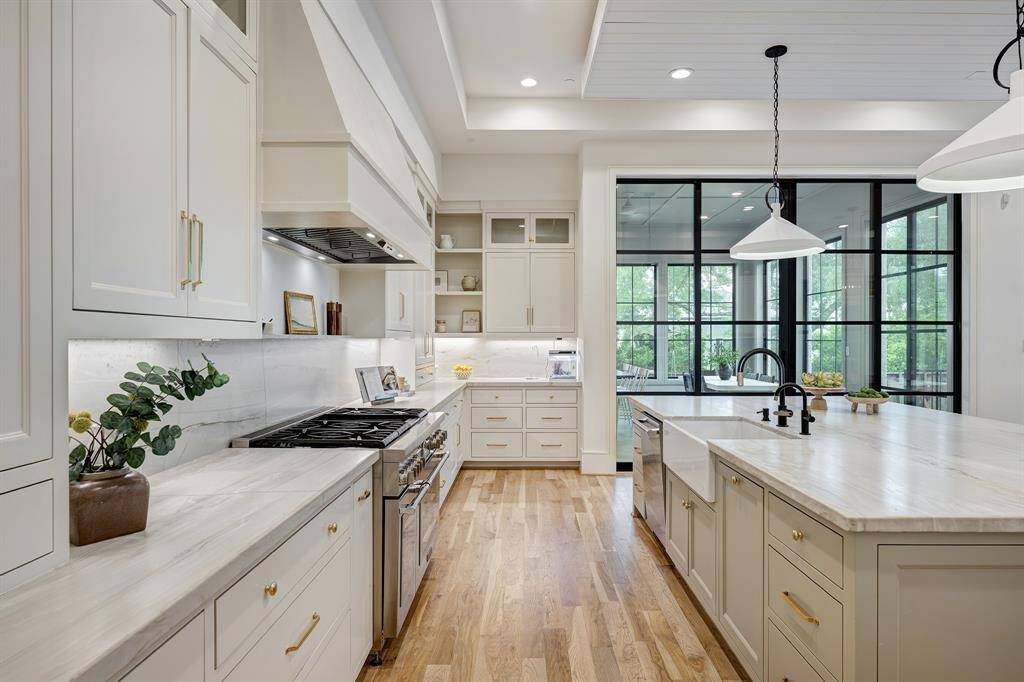 Perspective view of the kitchen showcasing the thoughtfully designed and integrated indoor/outdoor auxiliary kitchen patio, filled with natural light throughout the year.