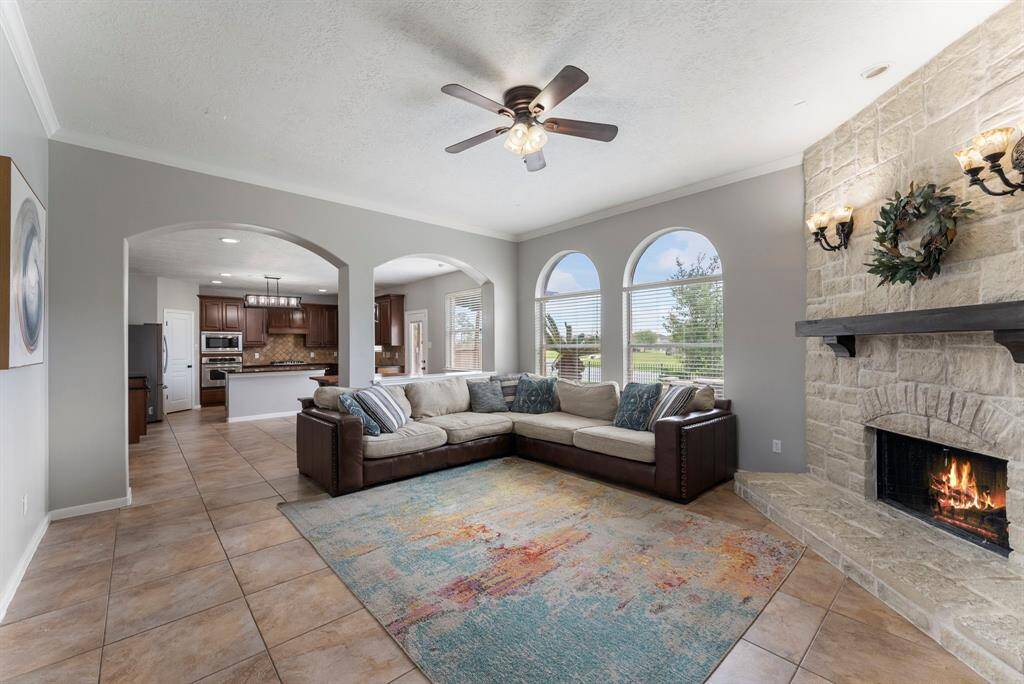 Plenty of space for your oversized furniture, all cozied up next to the striking stone fireplace with stained wood mantle.