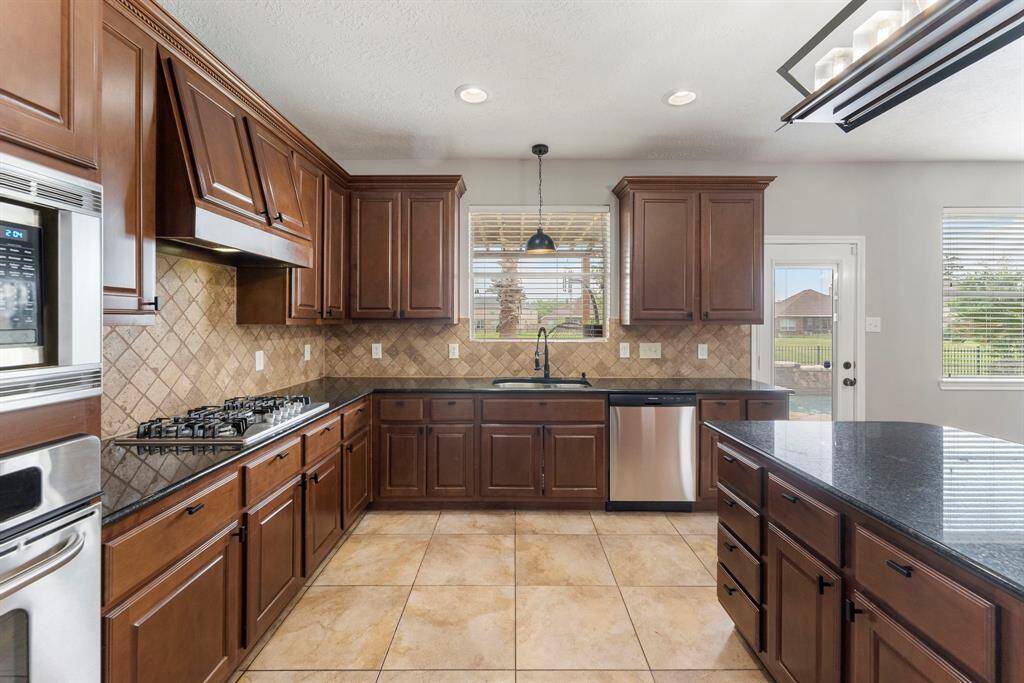 The chef of the home will love having all this counter and cabinet space at their disposal for meal prep. Note the extra storage built into the island!