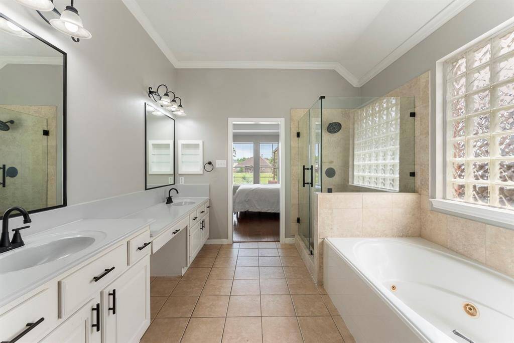 The primary bathroom has also been updated with new vanity mirrors, light fixtures and comes complete with a jetted tub.