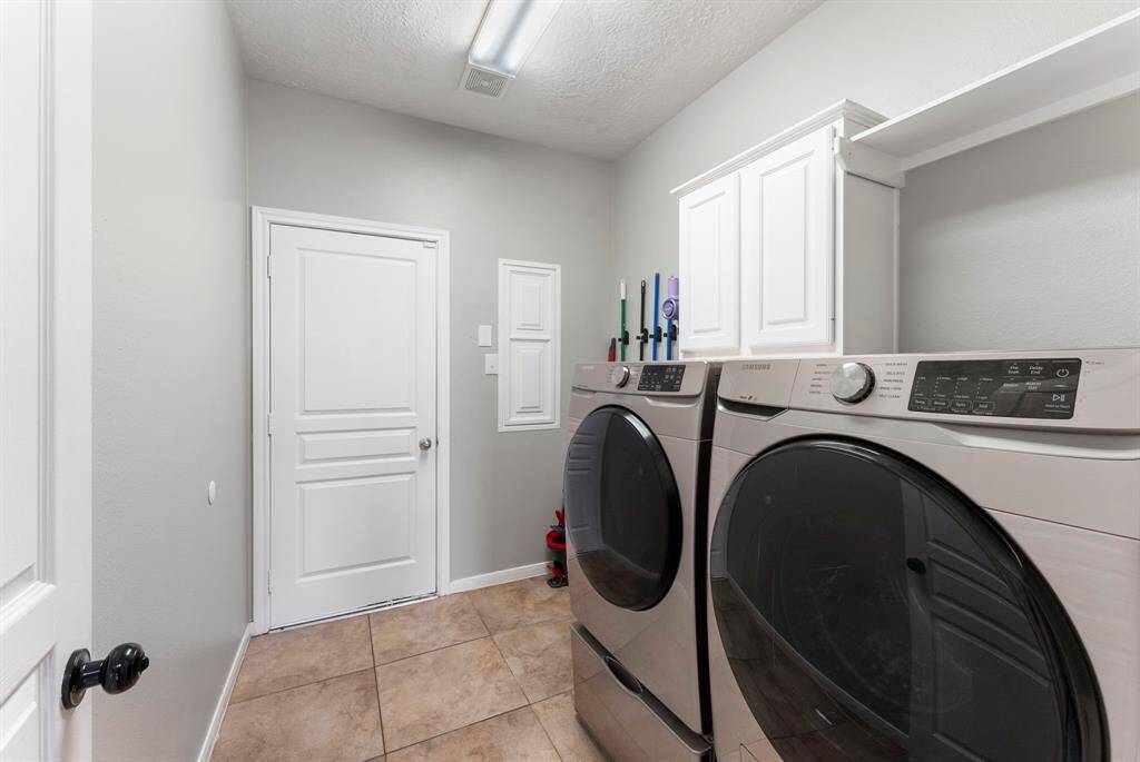 Large utility room with enough room for a second fridge and great bonus storage.
