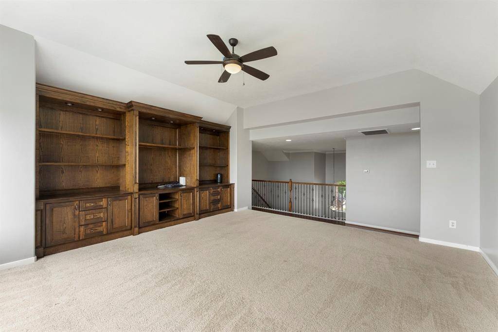The enormous gameroom features unbelievable views of the lake plus a wall of custom built-ins.