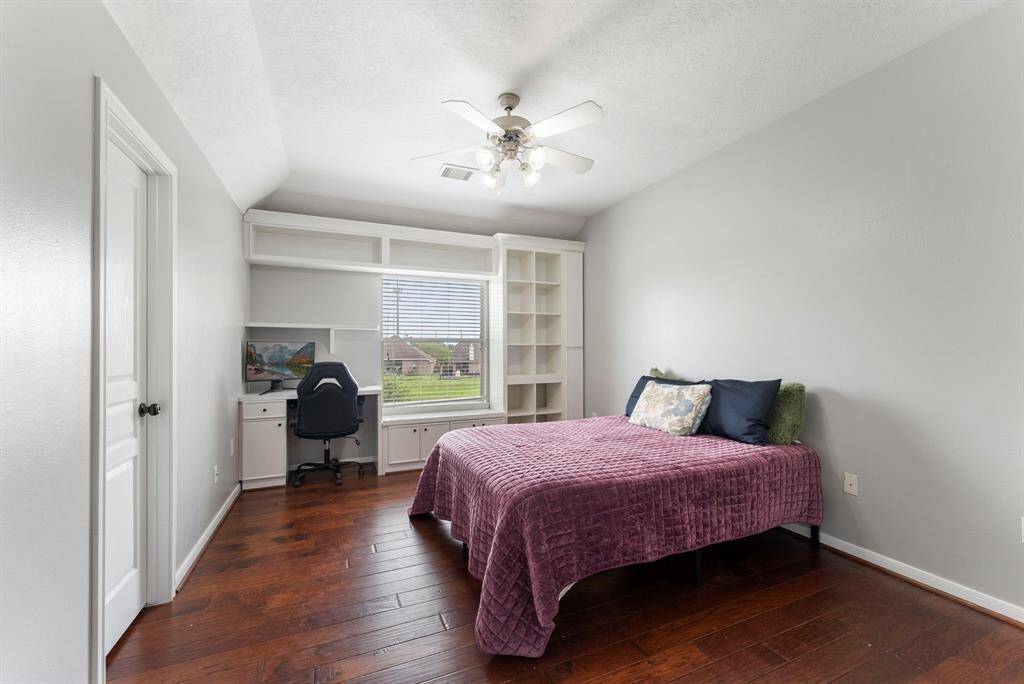 This upstairs secondary bedroom acts as a second primary bedroom up, with its huge space and its ensuite bathroom.