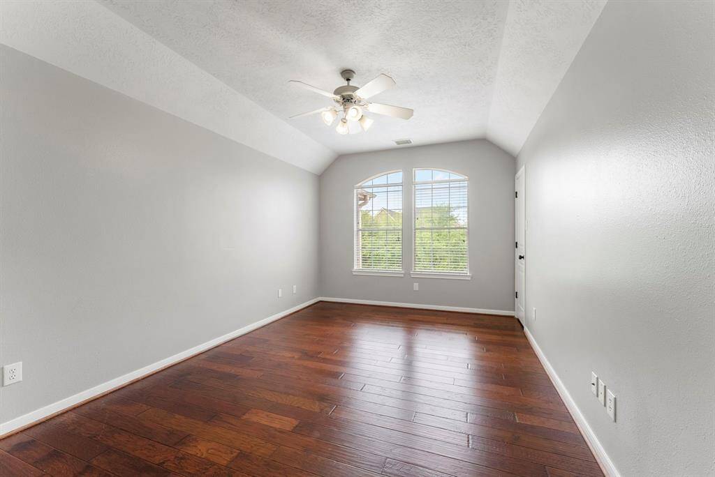 One of 3 bedrooms located upstairs. All secondary bedrooms are oversized and have high vaulted ceilings.