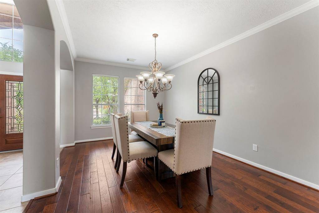 Formal dining room boasting hardwood floors, crown moulding, front yard views and plenty of space for your large dinner parties.