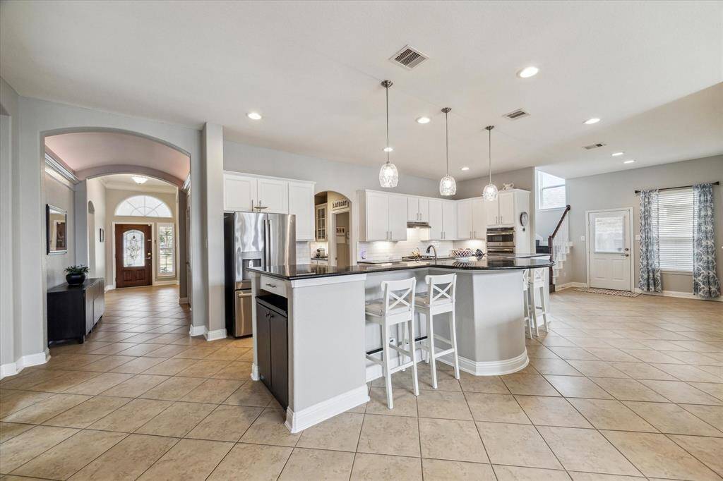 The living room view towards the foyer highlights this home's beautiful architectural lines.