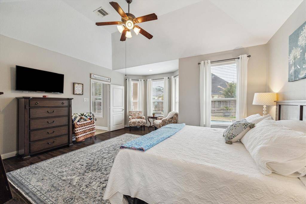 The primary retreat has coffered ceilings, crown molding, and great natural light from the windows.