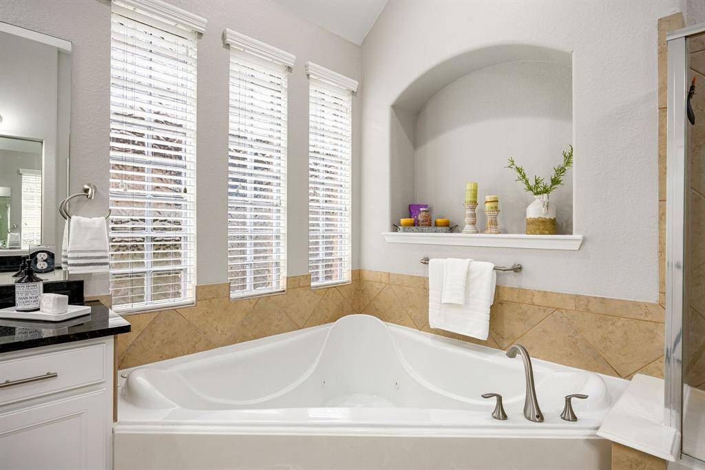 The spa like primary bath is completed with his and hers vanities.