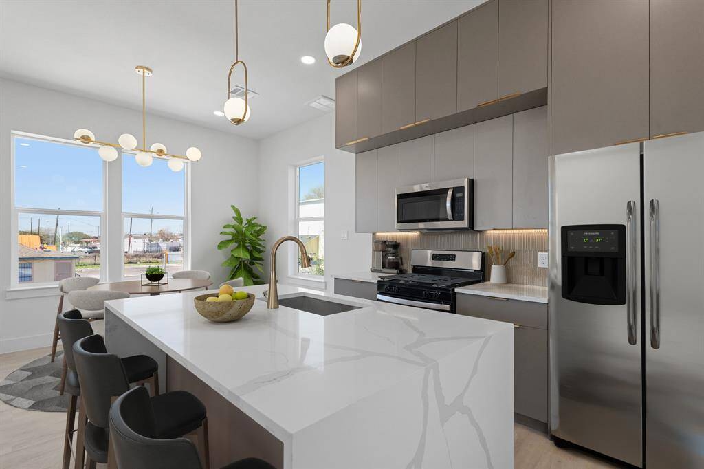 Virtually Staged: Host your next dinner party with confidence! This masterfully-equipped kitchen features a kitchen island, an abundance of new cabinetry, under cabinet lighting, quartz countertops, and stainless-steel appliances.