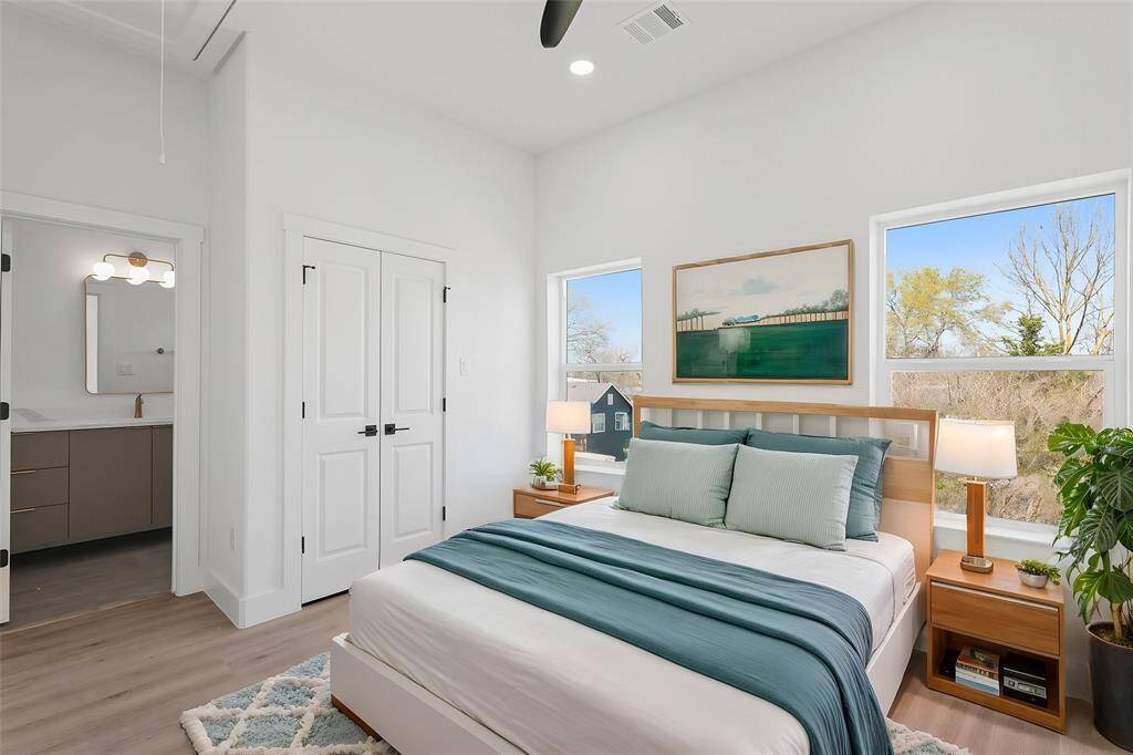 Virtually Staged: Secondary bedroom with vinyl plank floors, a built-in closet, and an ensuite bathroom.