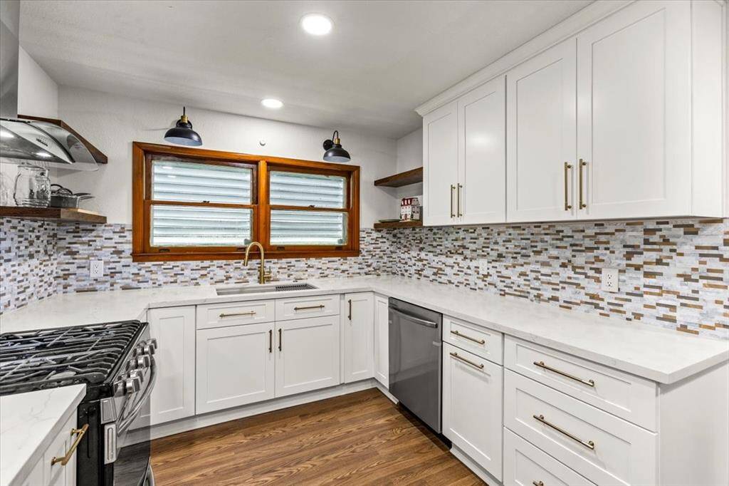 Kitchen provides ample counter space, and open shelving for a functional and aesthetic appeal.