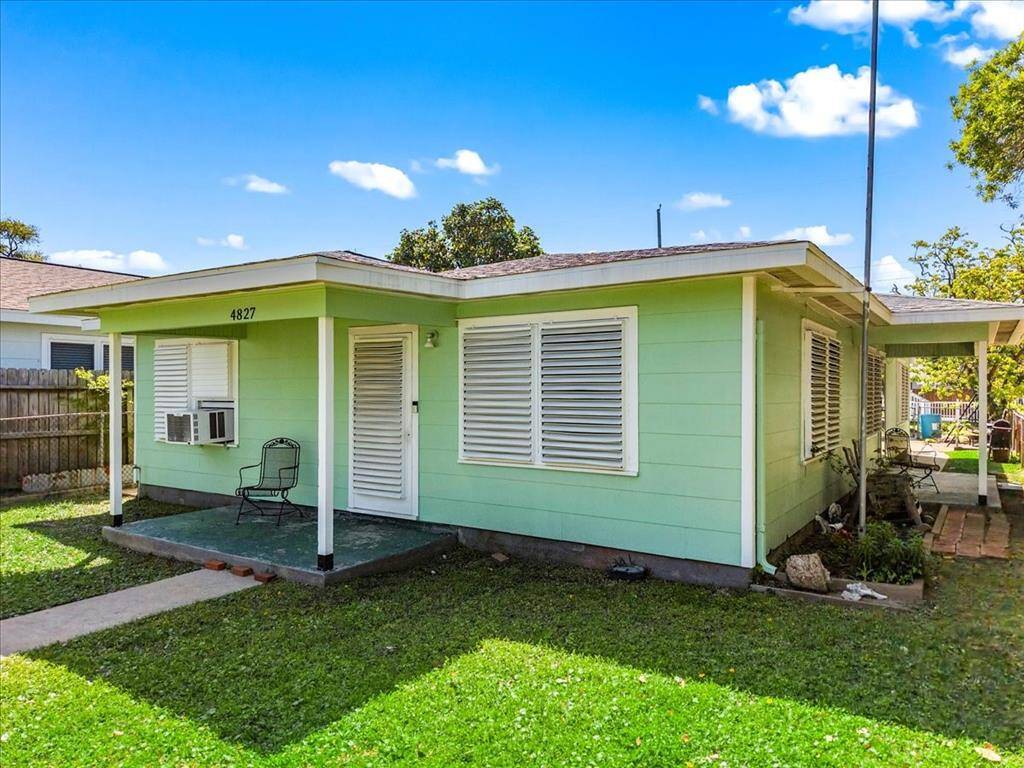 Newly painted green exterior, featuring a cozy front porch and a spacious yard. Ideal for those seeking a quaint and inviting living space.