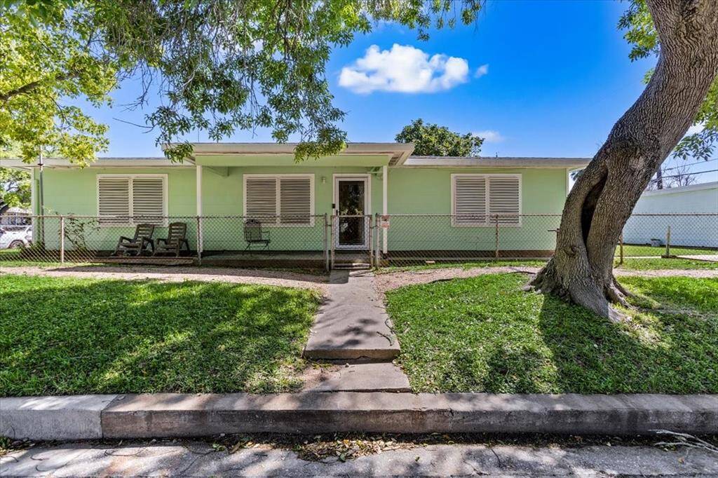 The side porch has a comfy seating spot—perfect for kicking back and enjoying the breeze.