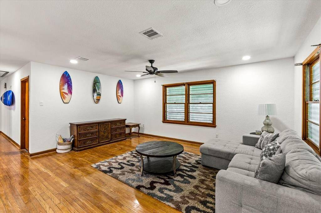 This living room is spacious and bright with hardwood floors.