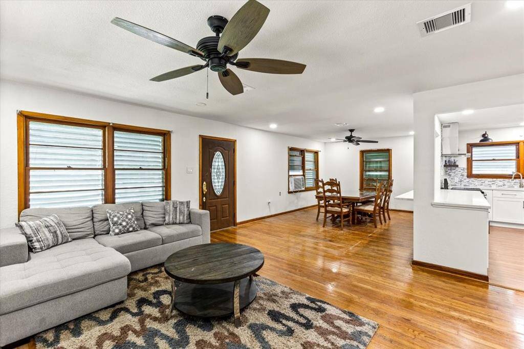 This inviting open-concept living space combines living room and dining area. The room is bright with natural light. Dining room opens up to breakfast bar, perfect for entertaining.