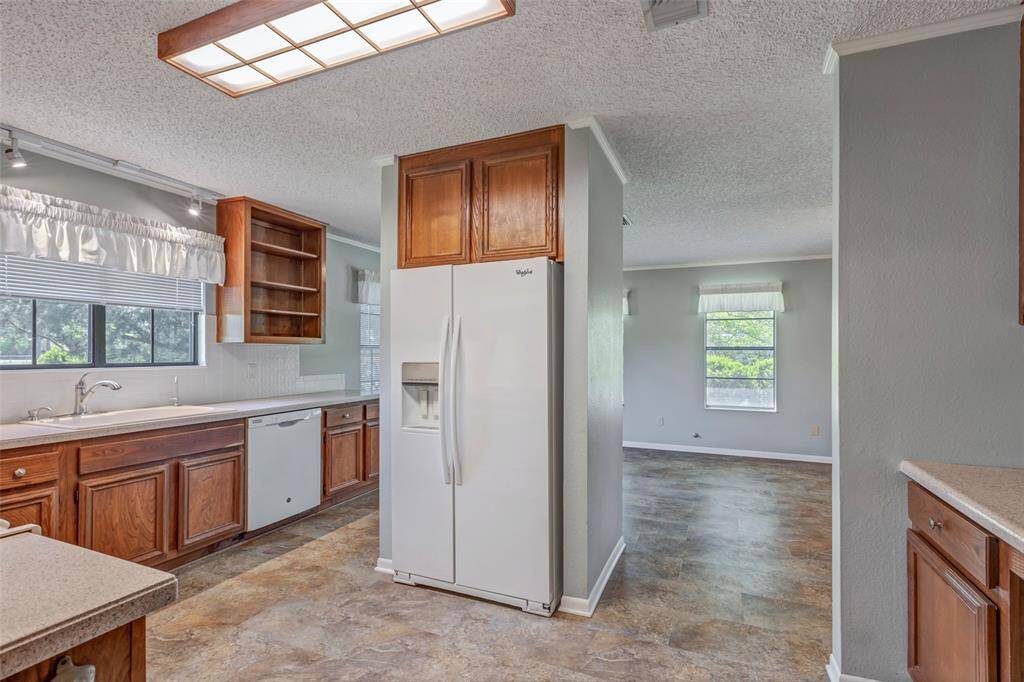 Open cabinet shelving and oversized kitchen sink.