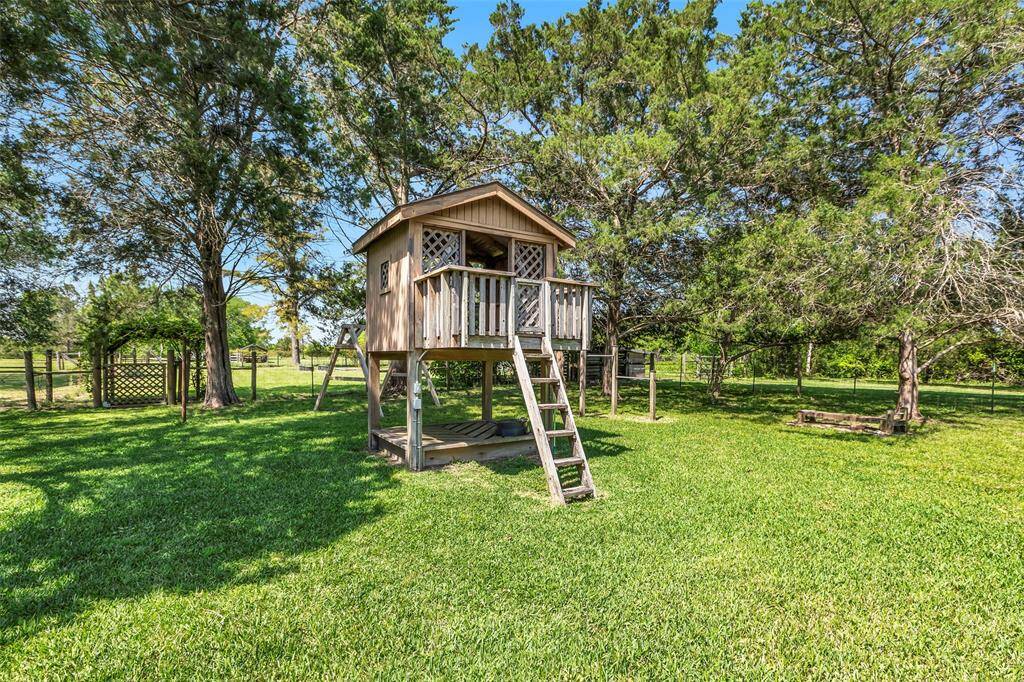 Adorable wooden playhouse with built-in bottom sandbox