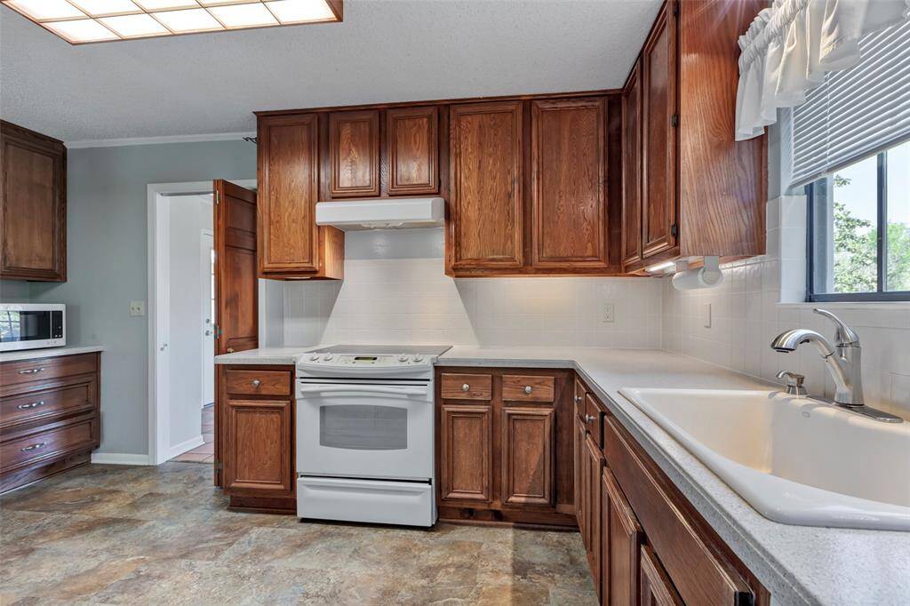 Another view of kitchen with added cabinet space to the left and beautiful view out the window to the right.