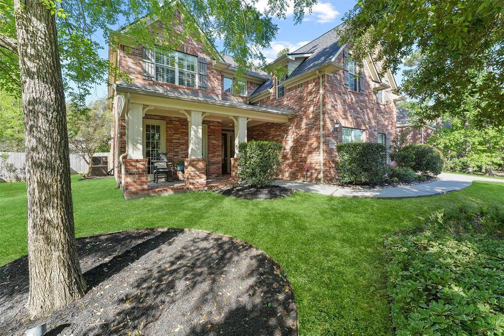 The home features a covered porch, shutters on the double paned windows, and a manicured lawn to enjoy the outdoors.