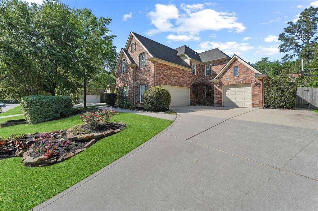 The property features an extra wide driveway and 3 car attached garage.